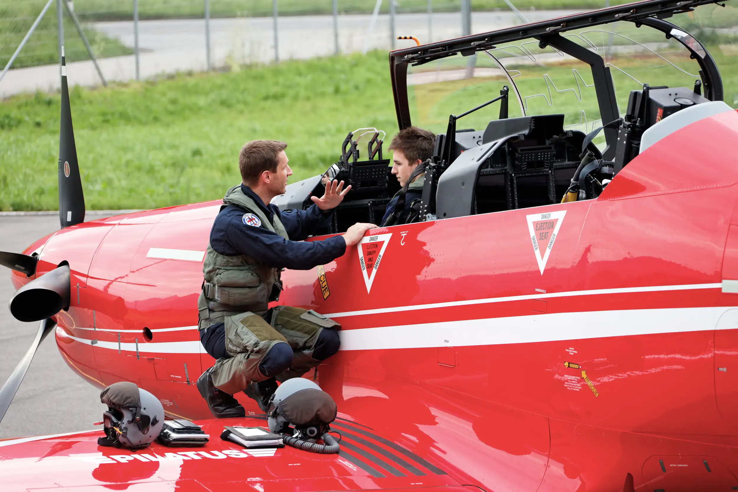 One pilot sits in the PC-21, while the other stands on the aircraft and explains. PC 21 Pilots Training