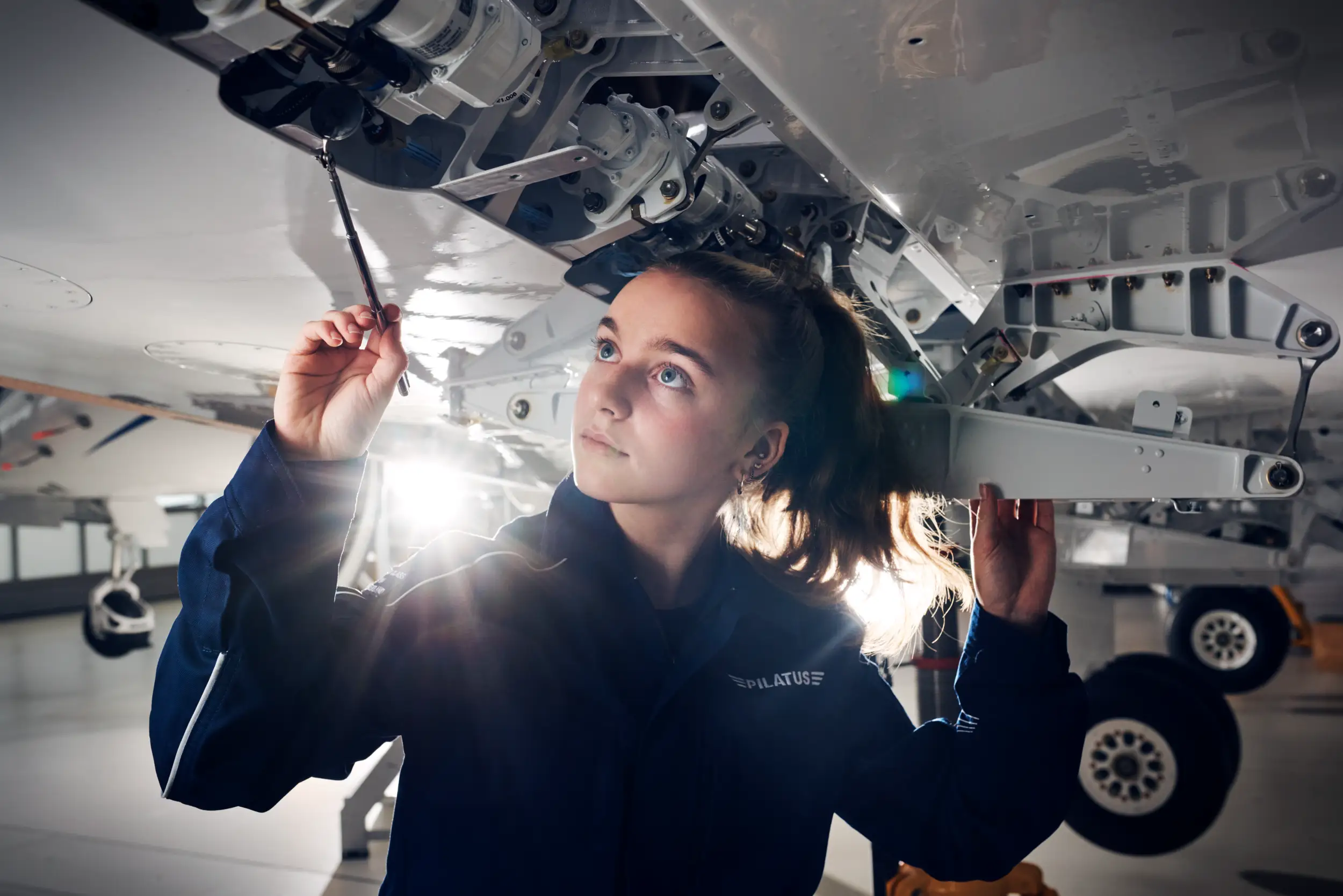 An employee is working on the aircraft.
