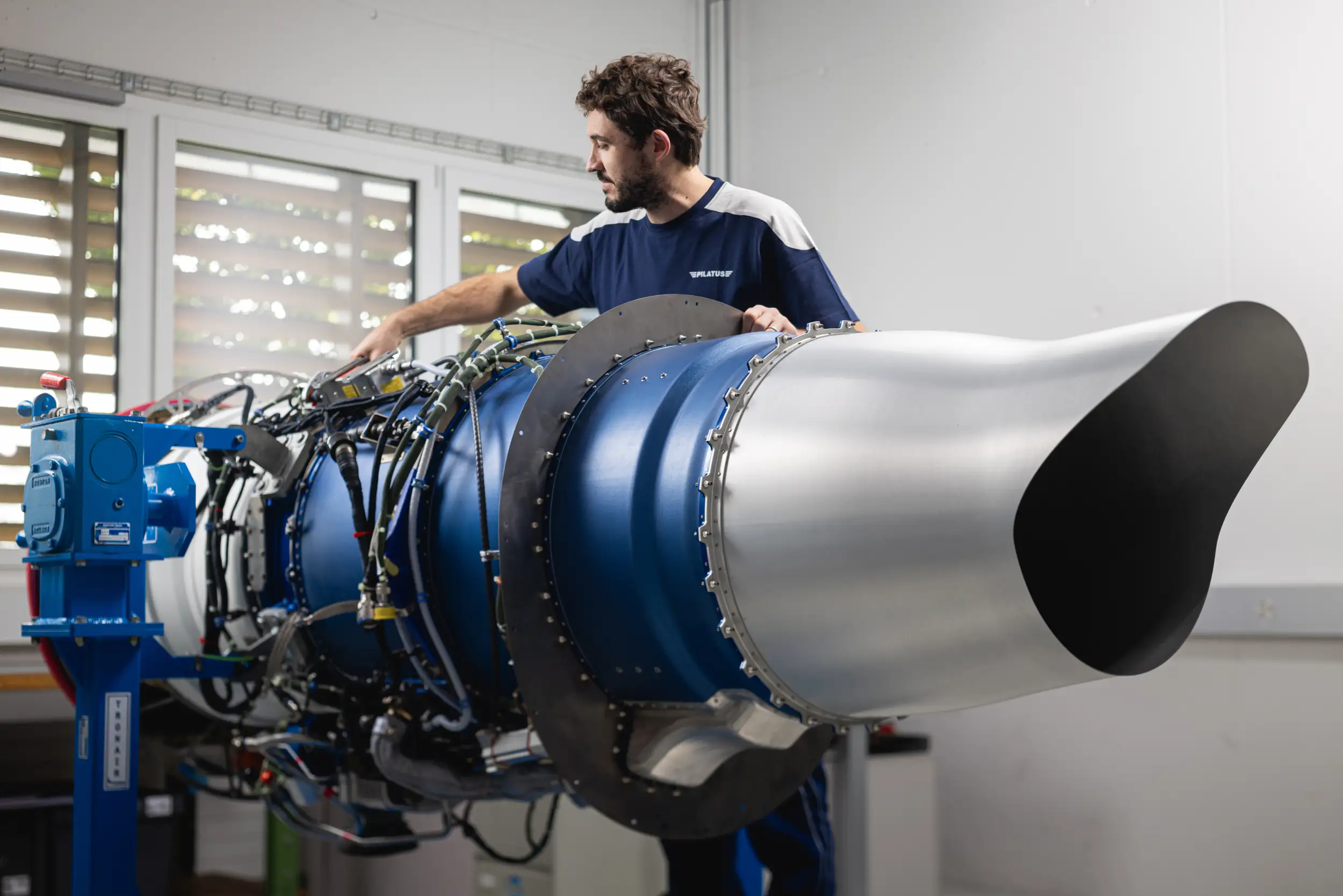 An employee is working on an engine.